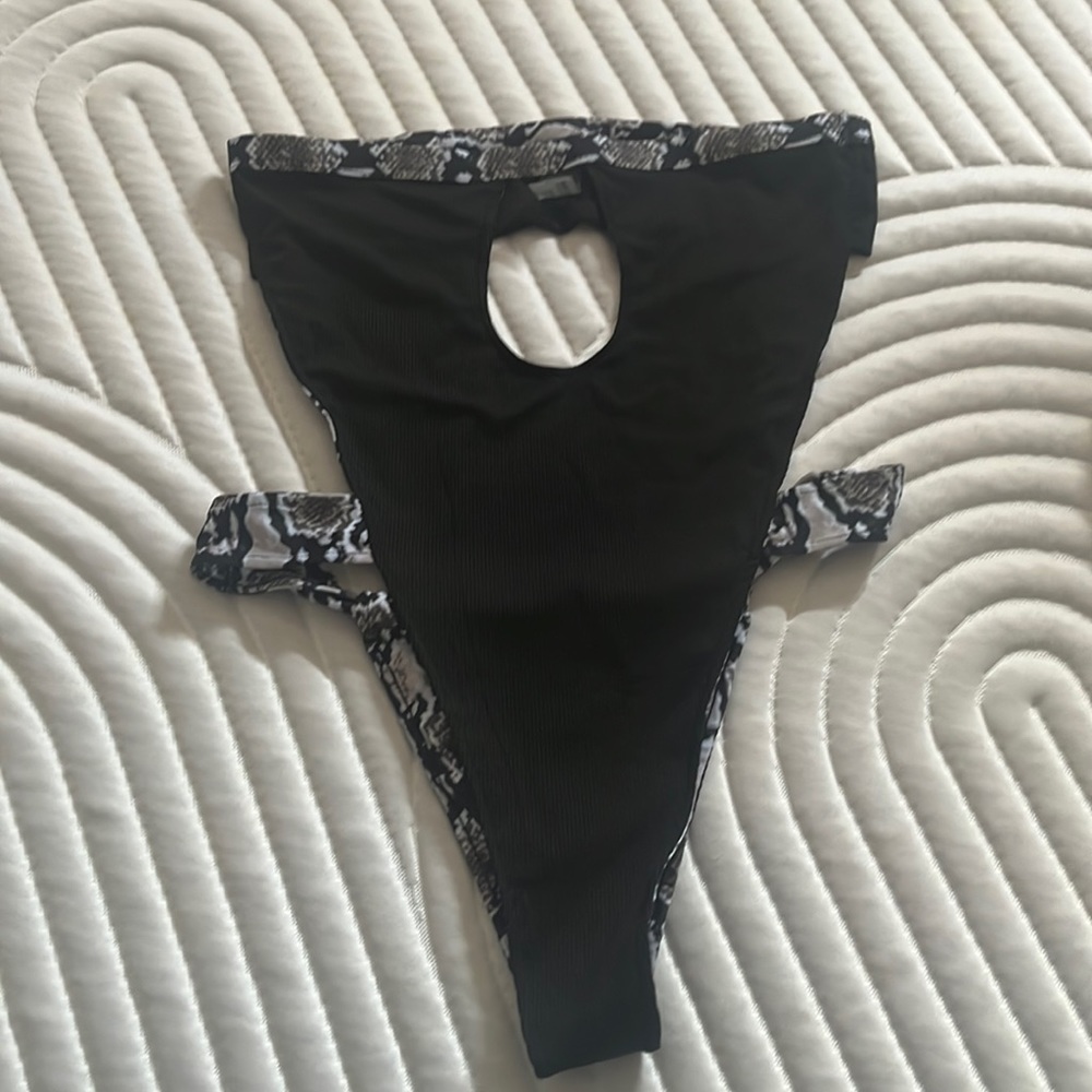 Black with animal print strapless bathing suit. Looks beautiful on